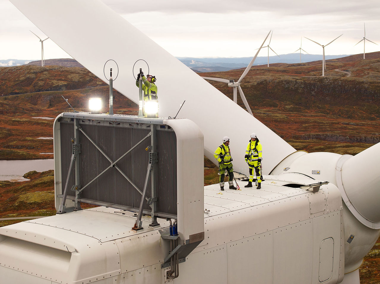To ansatte jobber på toppen av en turbin